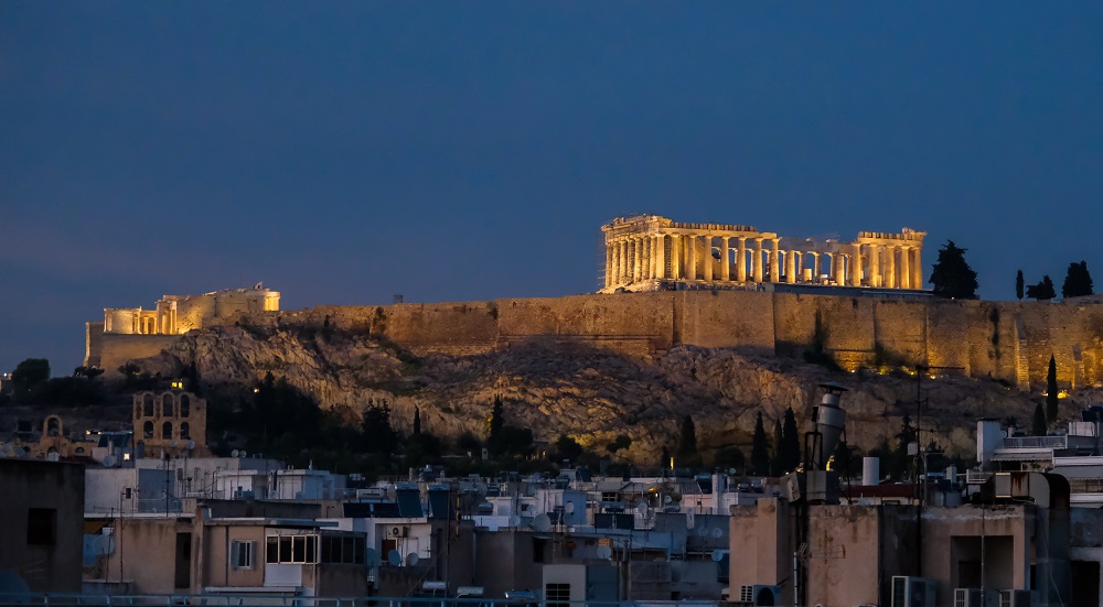 The Acropolis at night. Lit by lights between the columns.