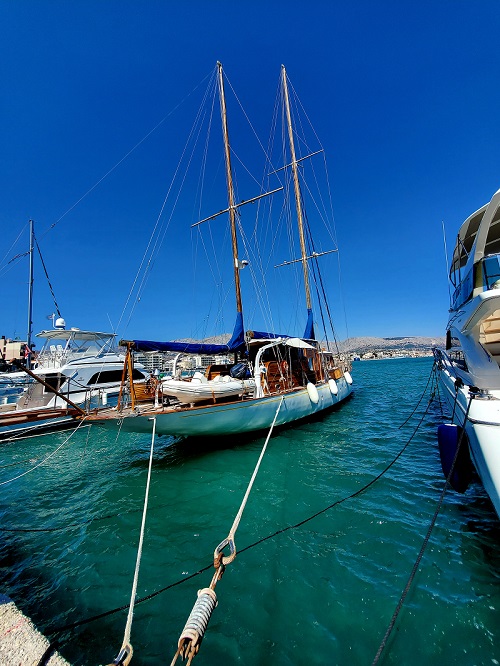 A large sailboat, docked in the aquamarine water of Chios.