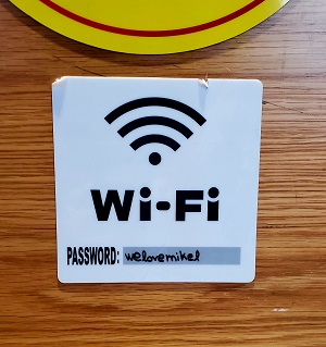 A WIFI symbol with password given. It includes the name Mikel.