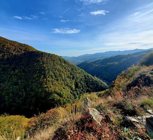 Overlook of the Transfăgărăşan in Romania. The hills and mountains are green with just the begining touch of fall in the leaves.