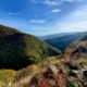 Overlook of the Transfăgărăşan in Romania. The hills and mountains are green with just the begining touch of fall in the leaves.